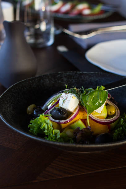 istock greek salad in dark dishes served in a restaurant 1221979113