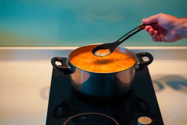 istock Cooking soup in a pan on an induction stove. 1221979967