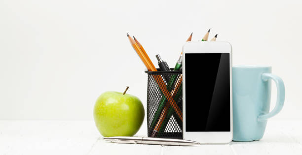 istock Workplace with smartphone, apple and coffee cup 1221980710