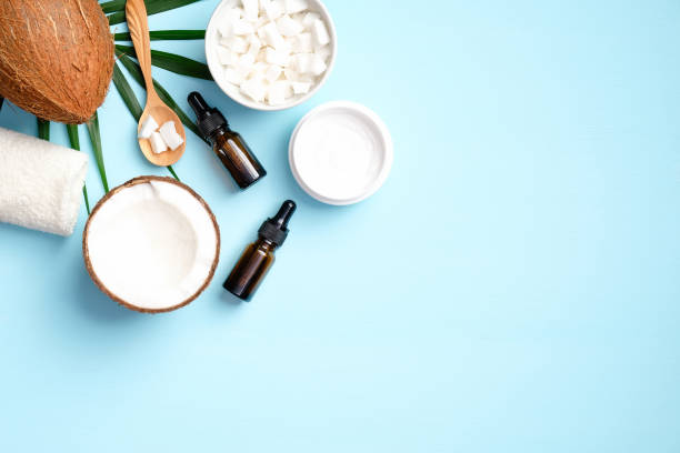 istock SPA natural coconut moisturizing cream and essential oil with palm leaf on blue background. Flat lay, top view. Organic beauty products for body treatment, skin care concept 1221982830