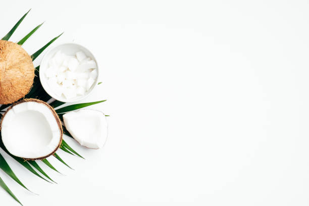 istock Summer background with coconut fruit and palm leaf on white background. Flat lay, top view, copy space 1221982972