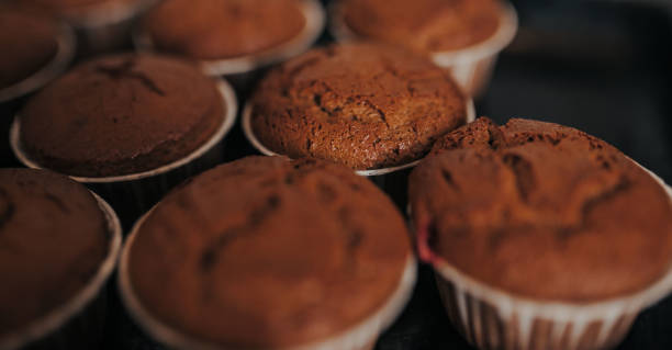 istock Chocolate muffins bakery. Brownie cupcakes on the baking pan. Baking at home, home bakery. 1221983182