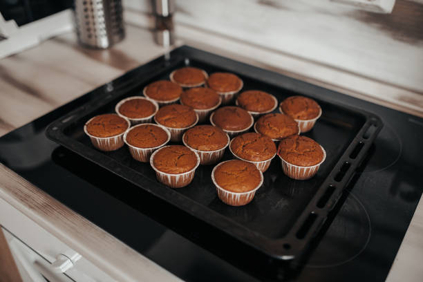 istock Chocolate muffins bakery. Brownie cupcakes on the baking pan. Baking at home, home bakery. 1221983224