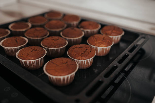 istock Chocolate muffins bakery. Brownie cupcakes on the baking pan. Baking at home, home bakery. 1221983247