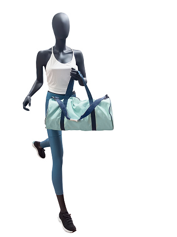 Running female mannequin with gym bag, isolated. No brand names or copyright objects.