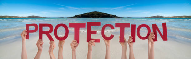 istock People Hands Holding Word Protection, Ocean Background 1221984703