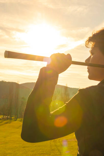 istock Golfer Leaning Her Golf Club on Her Shoulders with Sunlight 1221984868
