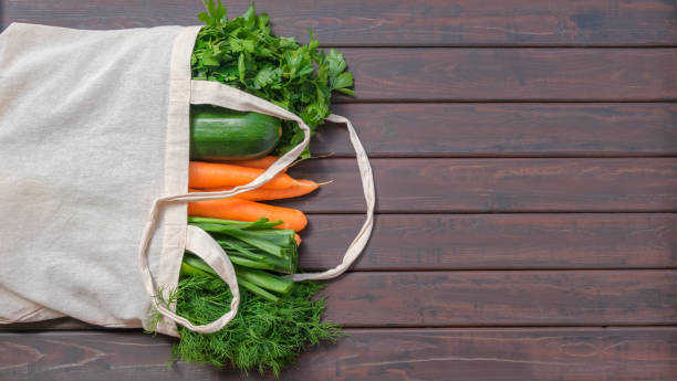 istock Textile bag with different food on dark wooden background 1221984953