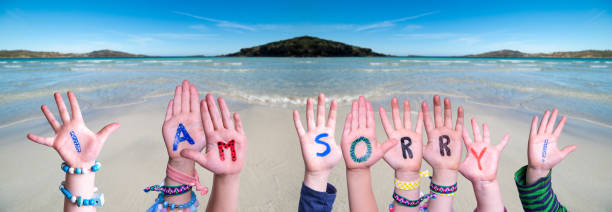istock Children Hands Building Word I Am Sorry, Ocean Background 1221986066