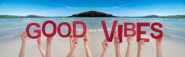 istock People Hands Holding Word Good Vibes, Ocean Background 1221986163