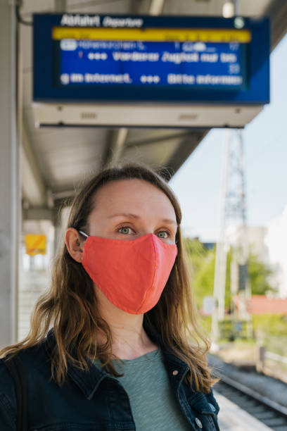 istock Woman wearing a protective face mask on public transport in Munich at Covid-19 exit barrier 1221987451