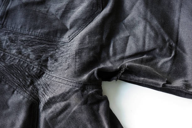 istock Old ragged shabby black jeans background, rag 1221988843