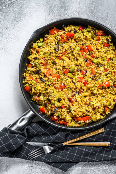 istock Cooked bulgur with vegetables in a pan. Gray background. Top view 1221990579