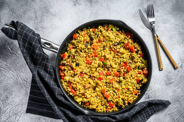 istock Cooked bulgur with vegetables in a pan. Gray background. Top view 1221990754