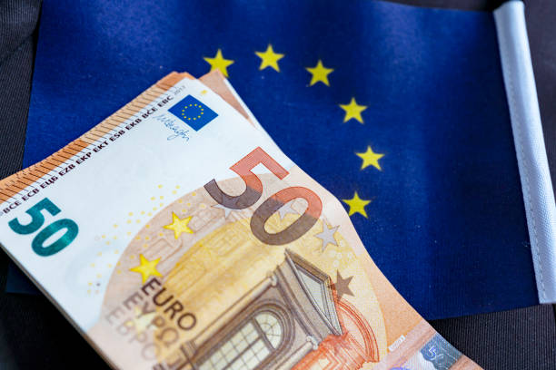 istock Euro flag and 50 Euro banknotes 1221990882