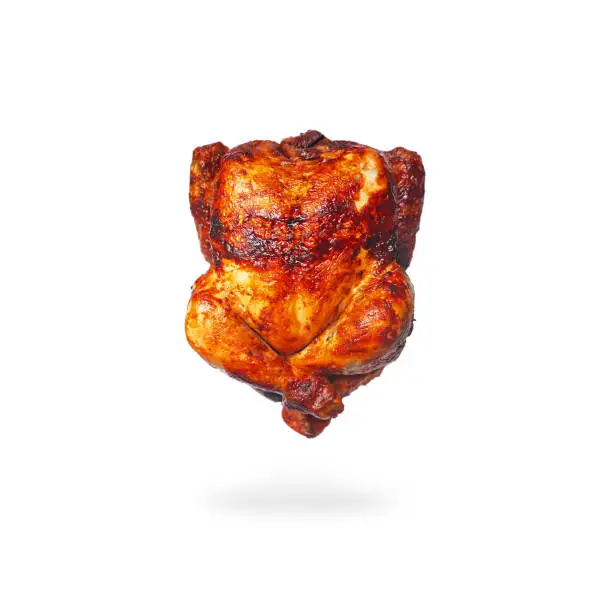 Photo of Smoked grilled chicken floating in the air in lotus position on a white background. Half roasted chicken