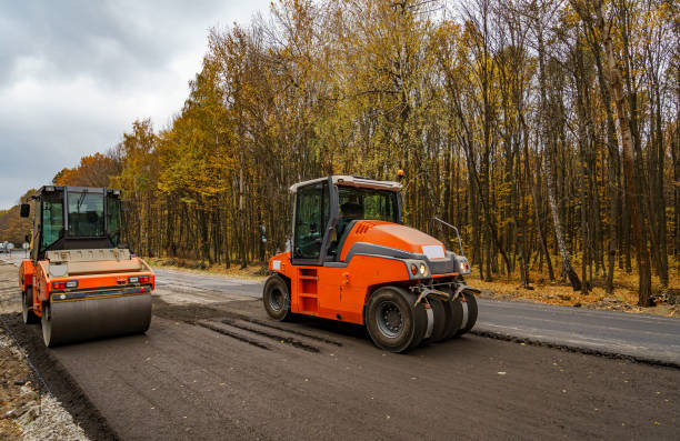 istock Large view on the road rollers working on the new road construction site. 1221991194