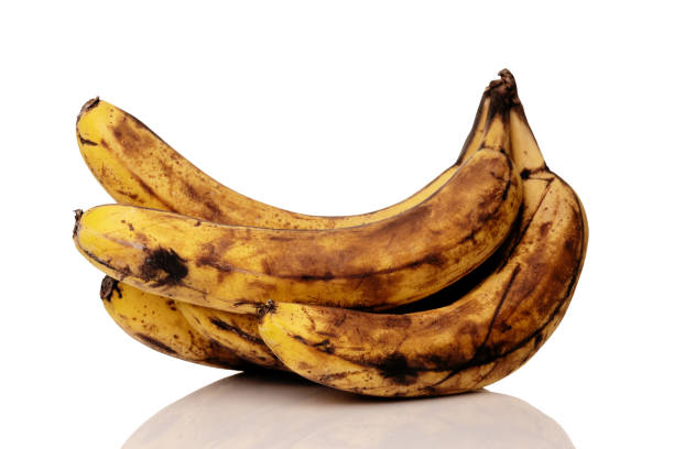 istock Over ripe bananas isolated on white with a reflection 1221992584