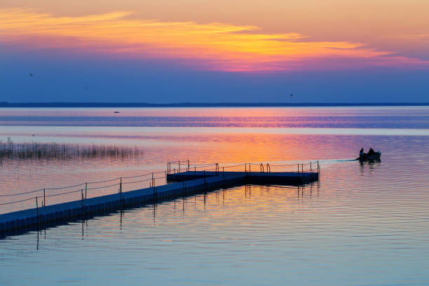 summer sunset on lake with boat