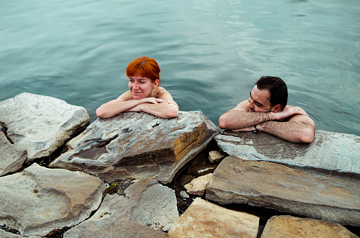 couple in love bathes in hot springs in iceland