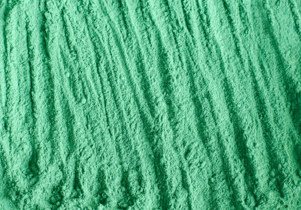 istock Green cosmetic clay powder (alginate facial mask, spirulina body wrap) texture close up, selective focus. Abstract background. 1221994166