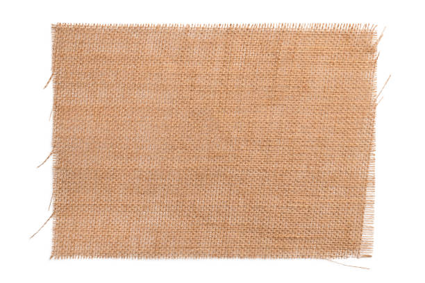 istock Old brown sackcloth from burlap. Wicker napkin isolated on a white background close-up 1221994534