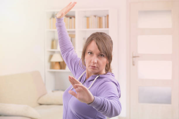istock Woman doing qi gong tai chi exercise 1221994554