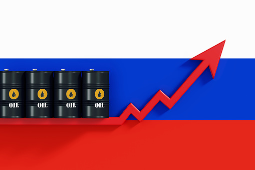 Black oil barrels sitting over a red arrow that is moving up on Russian flag. Horizontal composition with copy space. Global Oil industry supply and demand concept.