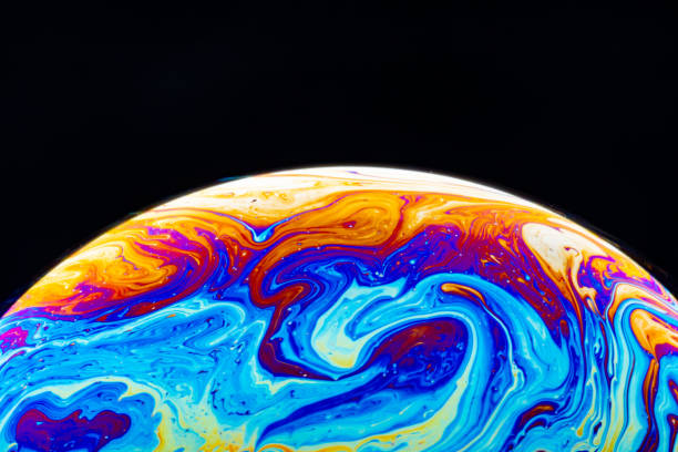 istock Macro shot of a soap bubble hemisphere. Abstract colorful liquid background. 1221995840