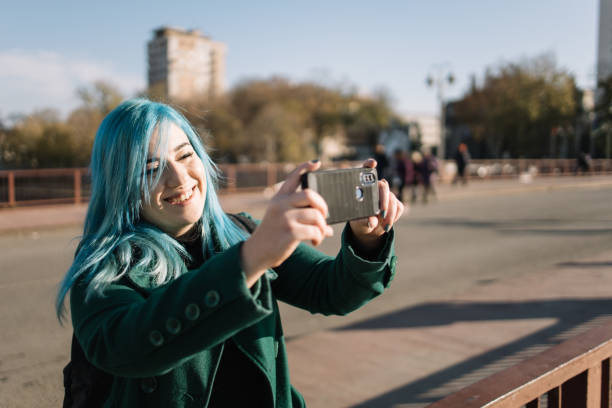 istock Happy girl making landscape photo on bridge 1221996659