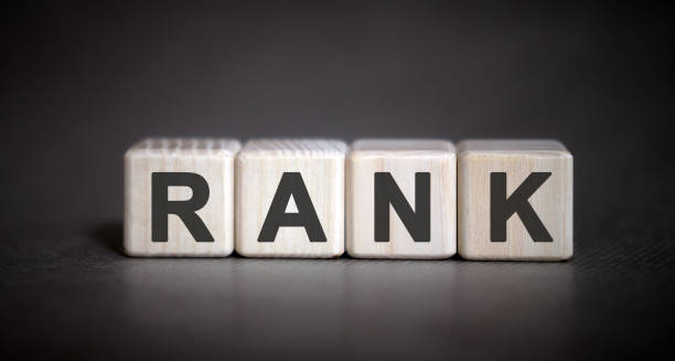 istock Rank - text on wooden cubes on a black background 1221997055