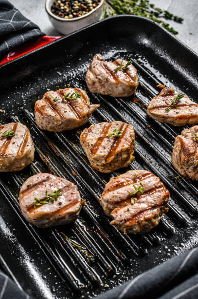 istock Tender boneless grilled pork chops. steak tenderloin. gray background. Top view 1221999921
