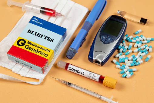 various elements of medicine on a orange background and a tube of blood test for covid-19. Box write Diabetes and generic Drug in Portuguese