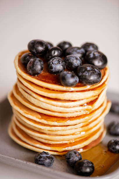 istock Stack of appetizing pancakes with honey and blackberries on plate 1222001443