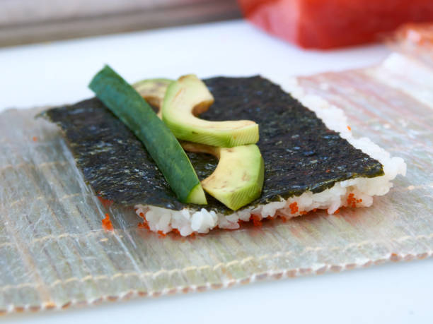 istock Cook hands making sushi roll closeup photo 1222001855