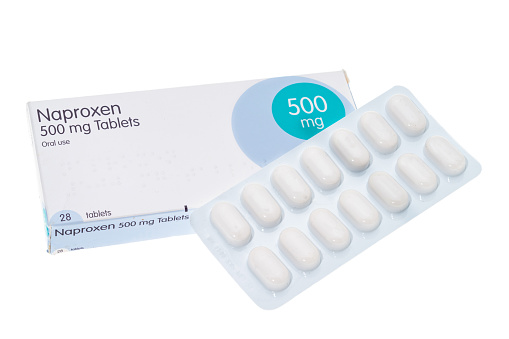 Box and blister pack of generic Naproxen anti-inflammatory pills - white background