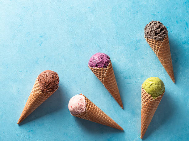 istock ice cream scoops in cones with copy space on blue 1222008236