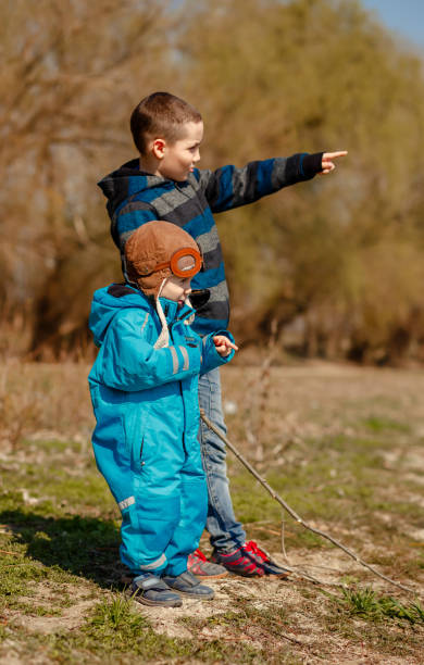 istock Two friendly brothers look into the distance. Play and Grow concept 1222010232