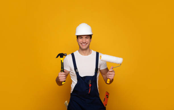 istock Ready to work. Close-up photo of attractive builder worker, who is looking in the camera, while holding numerous building tools in his hands. 1222011611