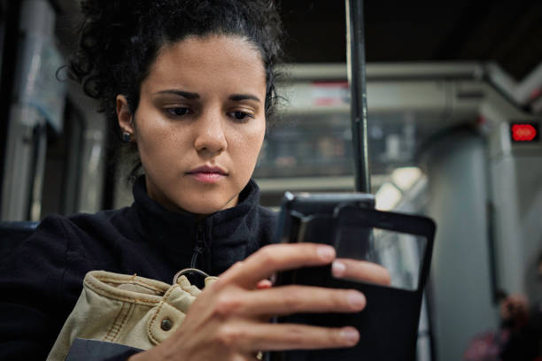 istock Hispanic young woman using mobile phone during travel in the subway 1222013136