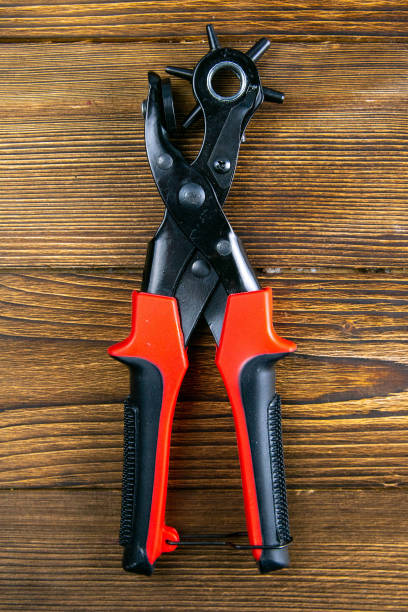istock Red hole punch on a wooden table. Top views, close-up 1222014590