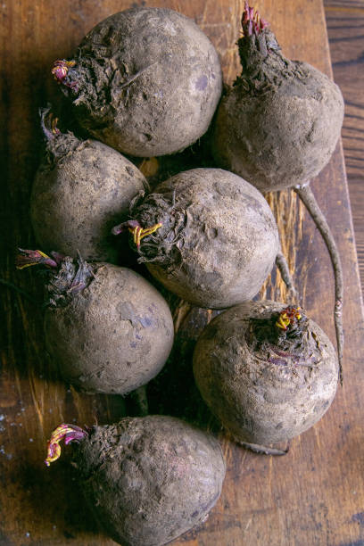 Fresh picked organic beetroot on old rustic wooden board, on wooden background