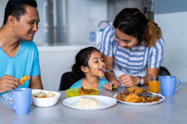 istock Multi Racial Asian Family enjoying lunch at home 1222014702