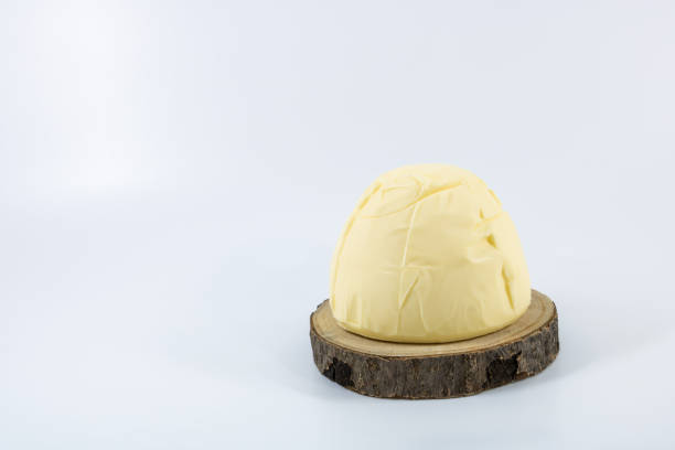 Breton butter motte churned and moulded to the old with a salty taste on a wooden studio photo tray on a white background stock photo