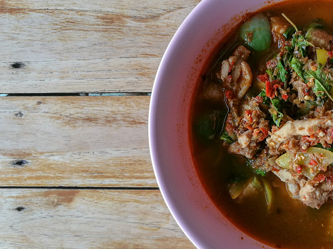 Thai food spicy soup with fish balls and herbs