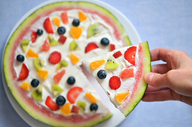 スイカピザエキゾチックフルーツサラダのスライス - serving food fruit salad human hand ストックフォトと画像