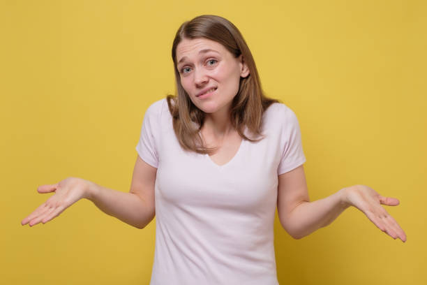 istock Attractive young woman shrugging her shoulders on yellow wall. 1222018221