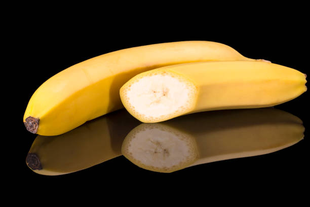istock Fruits of yellow bannan on black background, reflection 1222018459