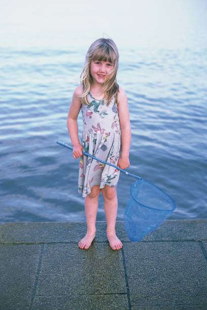 istock Young girl on a beach rockpooling 1222020044