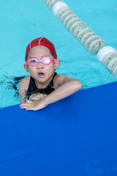 istock A kid feels tired in swimming class in the swimming pool. 1222020083